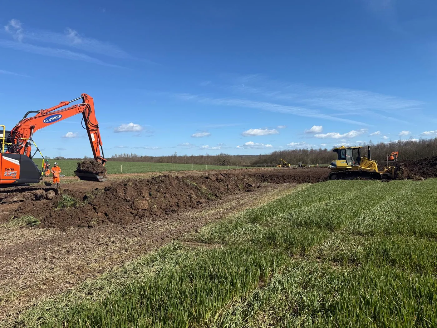Clumber Construction excavator and bulldozer trenching through farmland on Packington Final Effluent Rising Main, Leicestershire